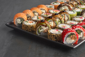 Sushi set. Roll with fresh ingredients on stone background.