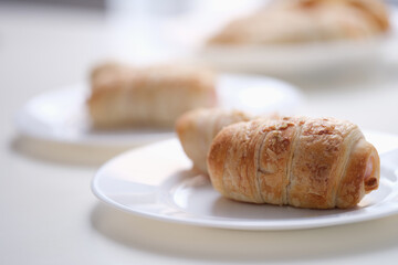 Homemade sausages in dough on white plate