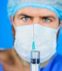 Vaccination and immunization. Doctor with syringe. Injection. COVID-19 vaccine. Selective focus.