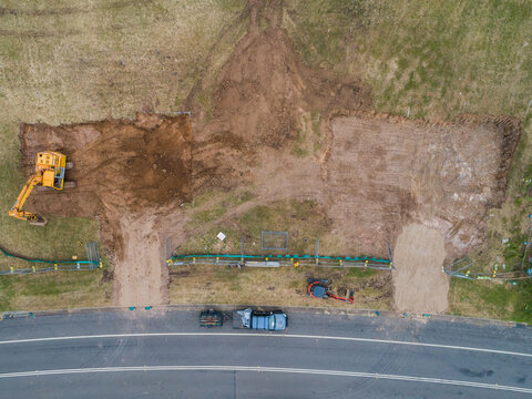 Construction site with digger levelling out ground for house build
