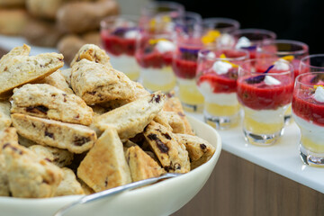 Bowl of cherry scones with yogurt parfait cups in background at a catered breakfast