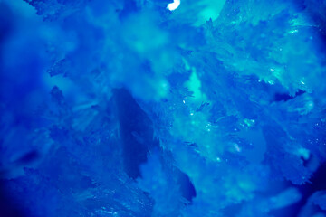 Fototapeta na wymiar Frosty drawing in blue colour on window