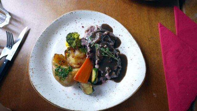 Gourmet meat on plate at restaurant