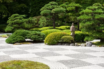 Fotobehang Zen Zen garden with raked stones and green vegetation  © Tamela