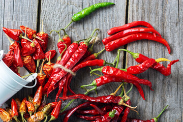different varieties of hot pepper, ground pepper and spices, a sheet of paper for the text recipe.	
