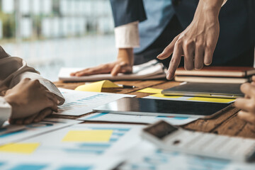 Obraz premium A desk in a company conference room has a group of business people attending and with supporting documents laid out, brainstorming sessions to fix and plan the company's growth. Business meeting idea.