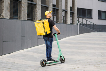 Delivery man of takeaway on scooter with isothermal food case box. Express food delivery service...