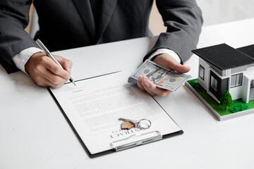 Real estate agents are drafting sales contracts for customers, drafting real estate sales contracts to be legal and fair to all parties. Real estate trading concept.