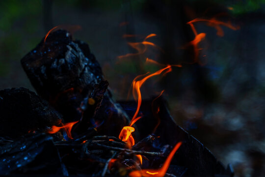 Burning fire in the grill with bright streaks of fire