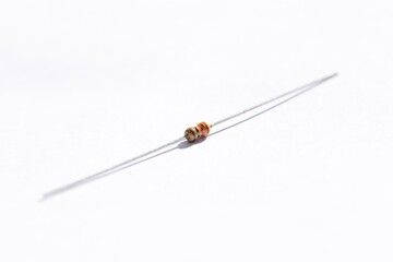 A portrait of a 330 ohm resistor with a 5% tolerance. The electric component is isolated on a white background and is ready to be used in an electronic circuit, breadboard or soldered on a PCB.