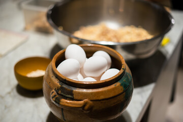 Fototapeta na wymiar Close-up of Clay pot with fresh white eggs in a kitchen