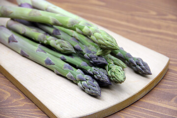 Fresh green asparagus on a wooden background