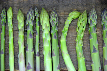 Fresh green asparagus on a wooden background