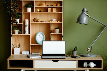 Front view background image of cozy home office workplace decorated by green houseplants, copy space