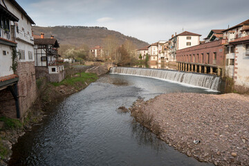 Fototapeta na wymiar Elizondo town capital of Batzan valley in Navarre Spain on mArch 1, 2022. Houses by the river.