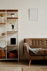 Vertical background image of minimal living room interior with cozy velvet couch and elegant decor © Seventyfour