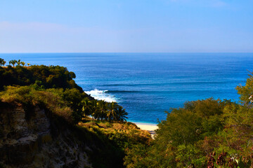 Fototapeta na wymiar cliff in front of the beach with blue sean in sunny day in puerto escondido oaxaca 