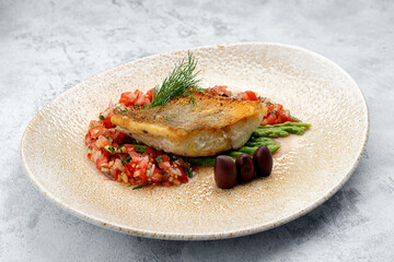 A piece of fried fish pike perch with vegetables