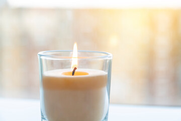 Obraz na płótnie Canvas aroma candle that burns on a background of sunlight.