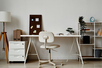 Background of simple home office workplace in white with bonsai tree on desk, copy space