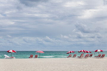 Red and white striped beach chairs and umbrellas on Miami Beach 