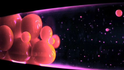 Lava lamp on black background. Concept. Close-up glowing neon bubbles of lava lamp move...