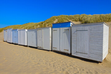 Fototapeta na wymiar Little beach cabins at a North Sea