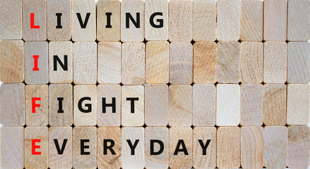 LIFE living in fight everyday symbol. Concept words LIFE living in fight everyday on wooden blocks on a beautiful wooden background. Business LIFE living in fight everyday concept. Copy space.
