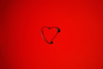 Still life of a heart shaped isolated object on a red background