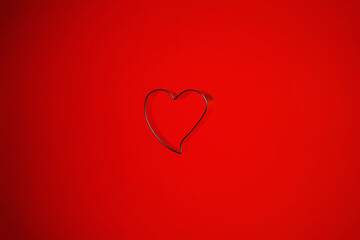 Still life of a heart shaped isolated object on a red background