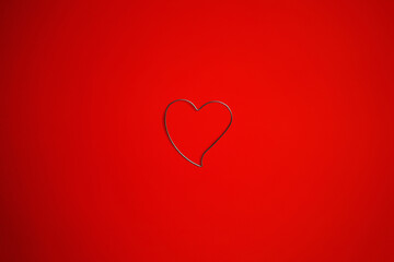 Still life of a heart shaped isolated object on a red background