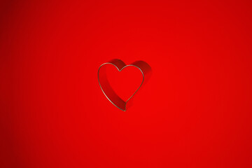 Still life of a heart shaped isolated object on a red background