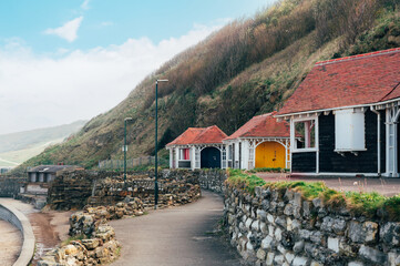 Colorful old beach huts or summer houses on South Bay Beach at Scarborough, Yorkshire, UK. Houses are old, paint cracks