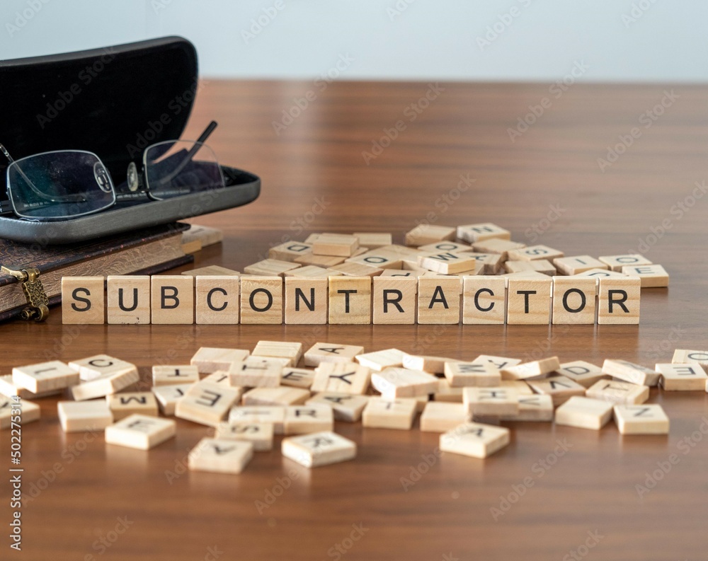 Poster subcontractor word or concept represented by wooden letter tiles on a wooden table with glasses and 