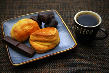 Dessert of cottage cheese, chocolate and dates in a plate on the table with a cup with the inscription 
