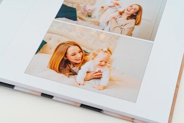 a Photobook of family at home on a white background. page with mom and daughter
