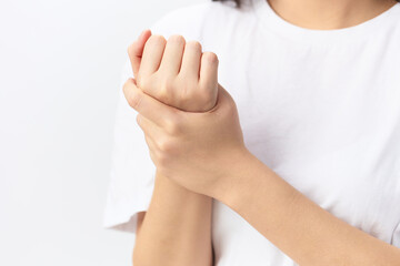 Broken hand Cramp. Closeup shot of suffering beautiful young Asian woman touch massage painful hand wrist posing isolated on white background. Injuries Poor health Illness concept. Cool offer Banner