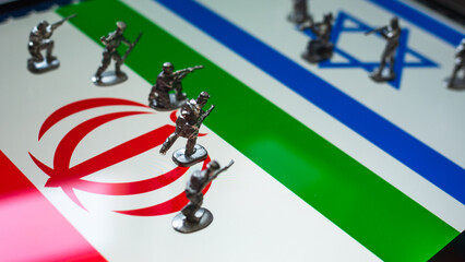 The concept of the economic and political crisis between Israel and Iran, toy soldiers attacking each other against the background of national flags.