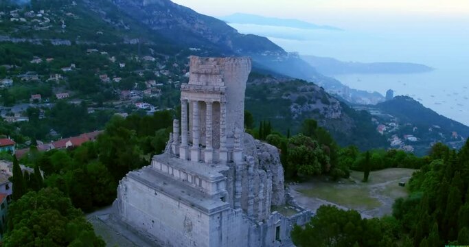 Aerial Forward Panning Shot Of Famous Monument Amidst Green Trees On Mountain - Monaco