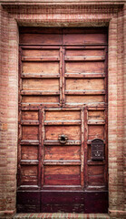 Old wooden door on a brick wall