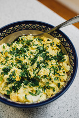 yellow potato salad with flat leaf Italian parsley