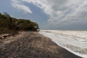 Palomino beach landscape with cloudy sky and black sand 