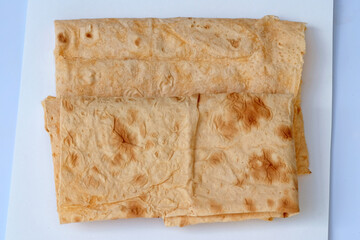 Thin folded Armenian lavash with paprika view from above. Thin lavash - traditional Armenian bread to shashlik