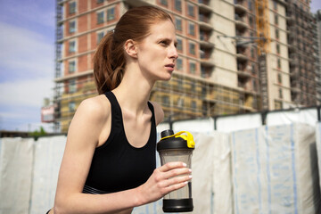 Sportswoman drinking water