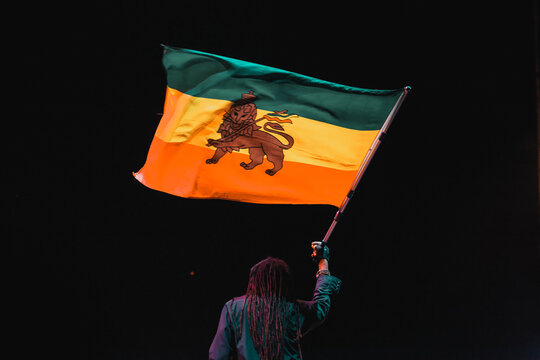 black man waving jamaica flag