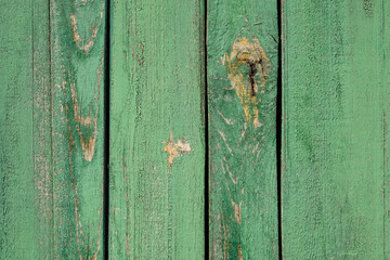 green wood background. Texture of wooden vertical boards. Old painted laths close-up. Rough board surface.