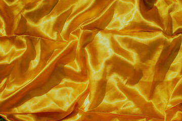 Natural silk background. Yellow fabrics or tissue