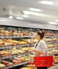 Woman choosing a dairy products at supermarket