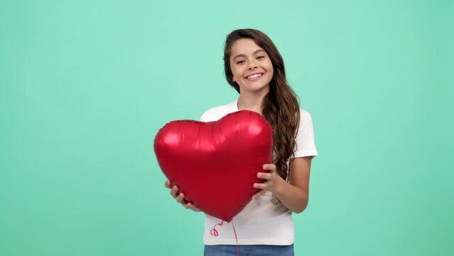 portrait of happy teen girl let fly heart party balloon symbol of charity and donation, love.