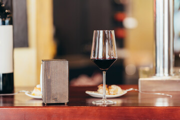 glass of red wine at the bar of a restaurant